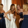 Bride and bridesmaids putting on the bridal sash