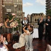 Groom dipping Bride during NYC Rooftop Ceremony Kiss