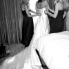 Black and White - Bridesmaids buttoning wedding dress
