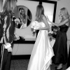 Bride adjusts her hair in the Mirror, going for the First Look
